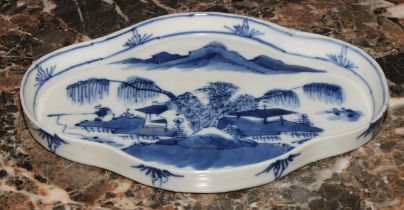 A Chinese quatrefoil dish, painted in tones of underglaze blue, with a fisherman in a landscape,