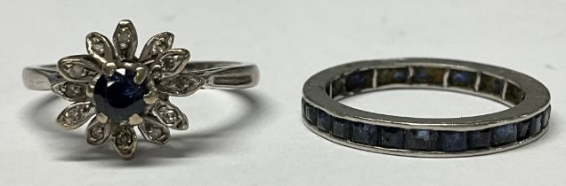 An unmarked white metal eternity ring, set with a band of blue stones, size N, 2.4g; an unmarked