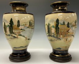 A pair of Japanese satsuma ovoid vases, hardwood stands, early 20th century