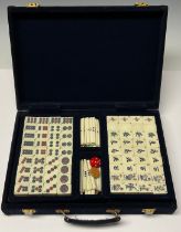 A Chinese Mahjong set, bamboo and resin pieces, in a blue velvet box, 31cm wide