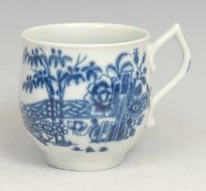 An early Worcester Plantation pattern bell shaped coffee cup, decorated in underglaze blue, tau-