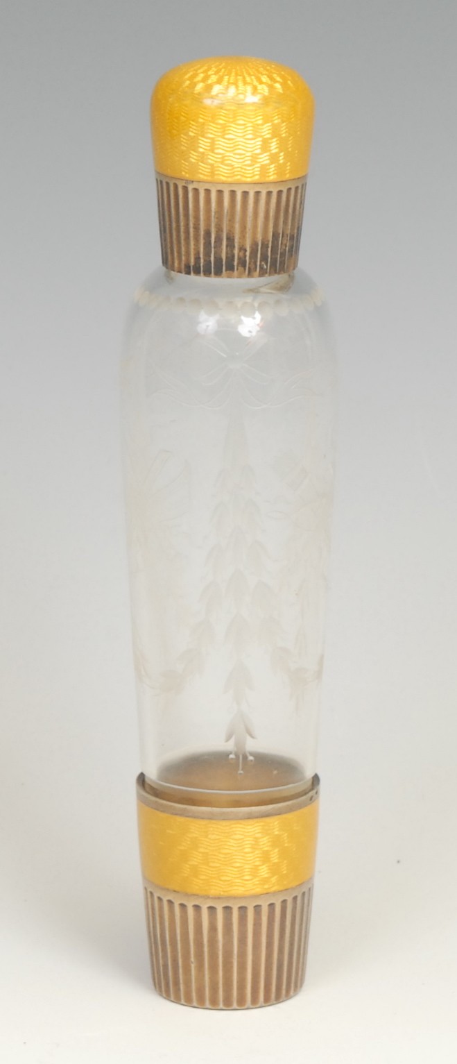 A 19th century French opera flask, mounted in engine turned yellow enamel, the glass engraved with