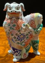 A Japanese porcelain figure, as a pair of dancers in Chinese temple lion costume, the rear dancer