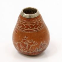 A South American gourd, carved throughout with a Gaucho on horseback chasing Rhea birds, unmarked