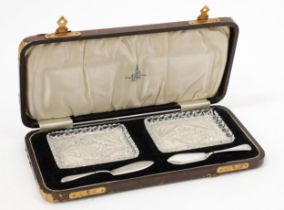 A George V silver and cut glass tête-à-tête butter dish set, comprising two rectangular shaped cut