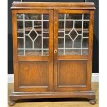 A Jacobean Revival oak leaded glazed bookcase, 107cm high, 83cm wide, 26.5cm deep, c.1930