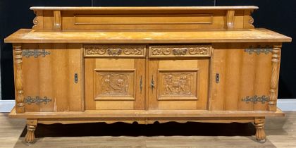 A large Continental design oak buffet sideboard, the central door panels carved as 18th century