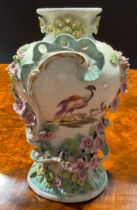 A Derby Patch Mark Rococo style pedestal vase, painted in polychrome with fanciful birds,