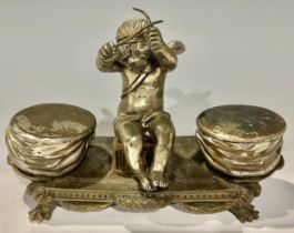 A French silvered bronze inkstand, as an amorini flanked by drums, 19cm wide, early 20th century