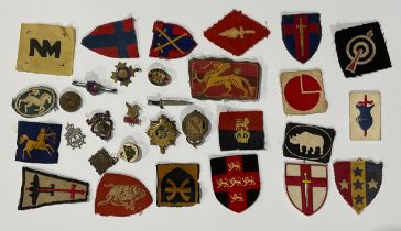 A collection of military patches and enamel badges