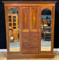 An Edwardian Sheraton Revival mahogany and marquetry compactum wardrobe, 216cm high, 192cm wide,