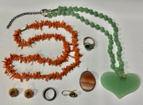 A Chinese jade pendant necklace; a coral necklace; an eternity ring; etc