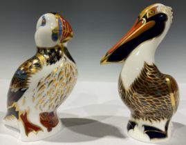 A Royal Crown Derby paperweights, Puffin, gold stopper, printed mark; another, Brown Pelican, gold