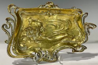 An Art Nouveau bronze tray, cast with the head of a young girl with sinuous flowing hair, 28cm wide,