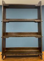 A 1920s oak Arts and Crafts open bookcase, peg fixings, impressed numbers 1-34 to shelf facings,