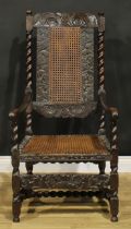 A 19th century Charles II Revival armchair, carved and caned in the traditional Carolean manner,