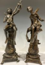 A pair of Art Nouveau style dark patinated bronze fairy musicians, signed in the maquette, each