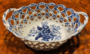 An Lowestoft two-handled oval basket, central oval reserve painted in underglaze blue with
