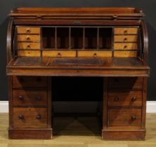 A Victorian mahogany twin pedestal cylinder desk, retractable door enclosing a writing surface,