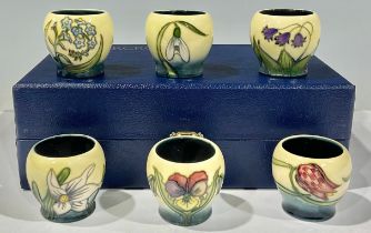 A set of six Moorcroft miniature vases, tube lined, various patterns, lined presentation box.