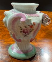 A Longton Hall asymmetric Rococo style pedestal vase, painted with flowers within moulded