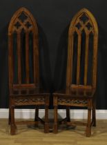 A pair of contemporary Gothic Revival style hall chairs, each with a tall lancet-arched