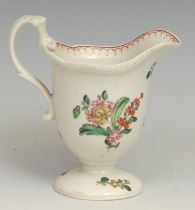 A Liverpool helmet shaped pedestal cream jug, painted in polychrome with flowers, red double-line