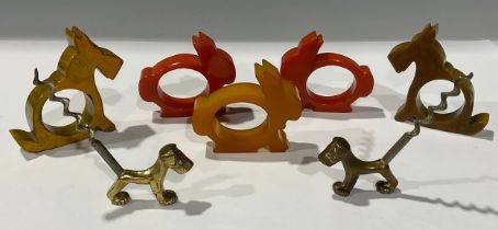 An Art Deco Bakelite animal napkin rings and corkscrews