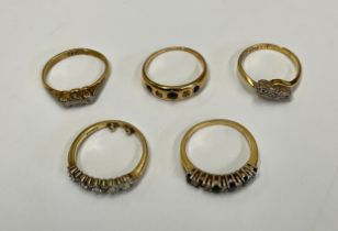 An 18ct gold diamond ring set with five baguette cut stones, interspersed with brilliants, size J/K,