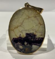 A 9ct gold mounted Derbyshire Blue John oval pendant, marked 375, mother-of-pearl to verso, the