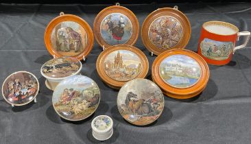 A collection of Staffordshire Prattware pot lids, including Albert Memorial, War, Peace, Snap