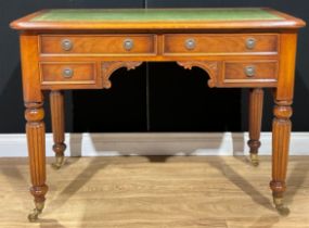 A Victorian style writing desk, tooled and gilt writing surface, brass casters, 79cm high, 107cm