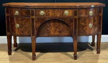 A George III mahogany serving table or sideboard, slightly oversailing top above an arrangement of