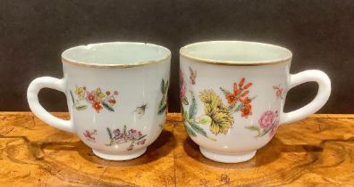 A pair of Chinese coffee cans, London decorated in polychrome enamels, with colourful flowers and