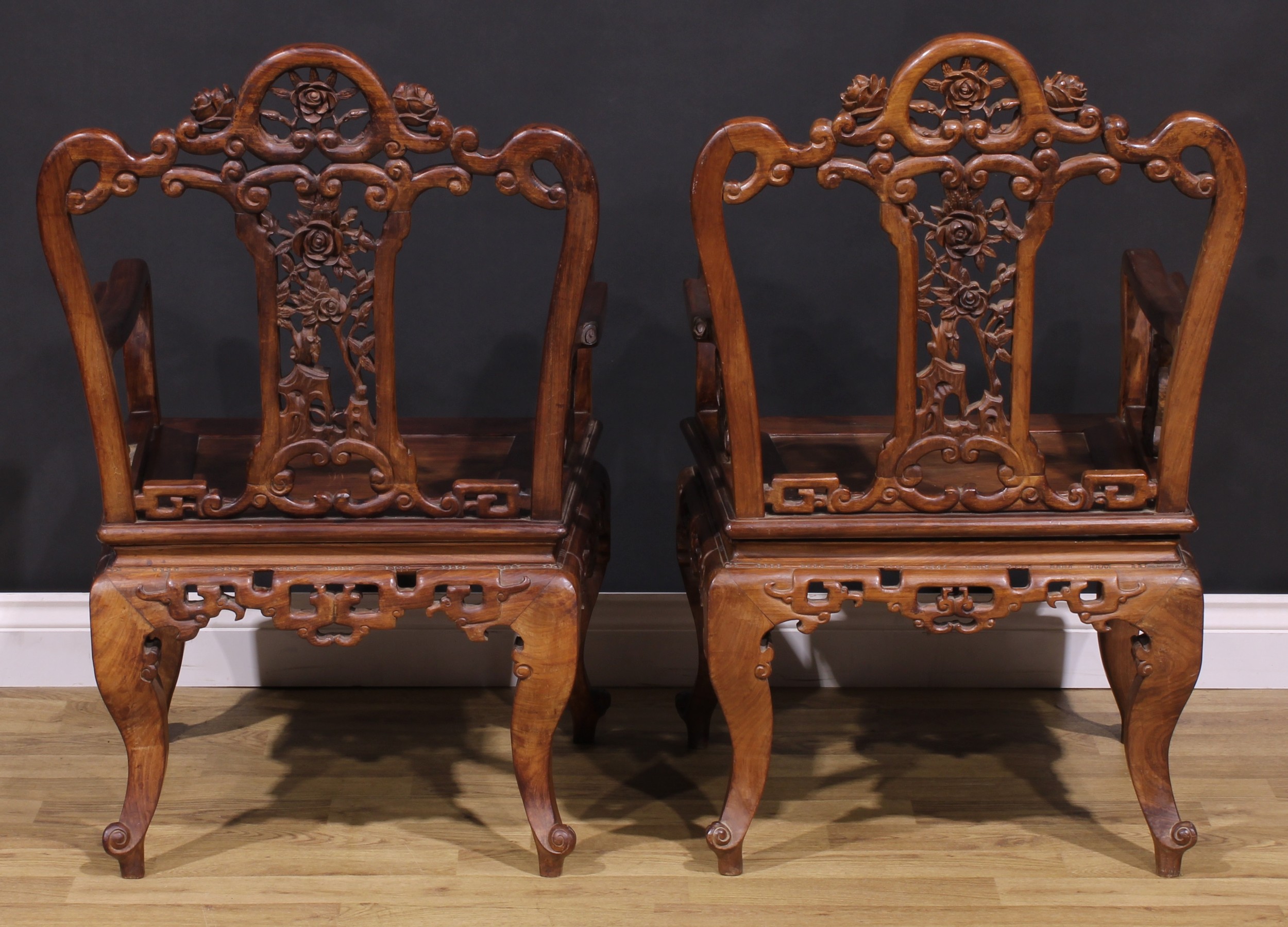 A pair of Chinese hardwood armchairs, each with a shaped back pierced and carved with scrolls and - Image 4 of 4