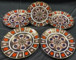 A pair of Royal Crown Derby Imari 1128 pattern dinner plates, first quality, 27cm; two others, one