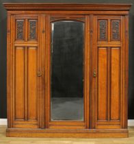 A late Victorian Aesthetic Movement walnut wardrobe, by Druce & Co, badged, 220cm high, 211cm