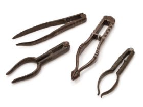 Nutcrackers - a 18th century iron lever-action nut cracker, 11.5cm long; another, acorn terminals,