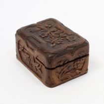 A Black Forest travelling pocket watch box, carved with flowers, scrolling leaves and strapwork,
