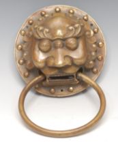 A substantial Chinese brass door knocker, cast as the head of a temple lion, 15cm diam