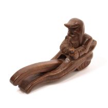 Nutcrackers - a Black Forest lever-action novelty nut cracker, carved as a gnome, seated, holding