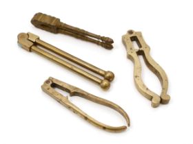 Nutcrackers - a 19th century brass lever-action nut cracker, globular terminals, 12.5cm long; others