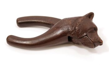 Nutcrackers - a Black Forest lever-action novelty nut cracker, carved as the head of a bear, 17.
