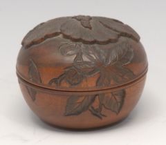 A Japanese boxwood box and cover, carved with a lotus, signed paper label, 7cm diam,