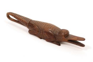 Nutcrackers - a 19th century treen novelty screw-action nut cracker, carved as a crocodile, 22cm