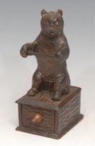 A Black Forest novelty cotton reel holder, carved as a bear, drawer to base, 15cm high