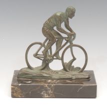 Cycling - an Art Deco verdigris patinated desk model, of a gentleman riding a bicycle, rectangular