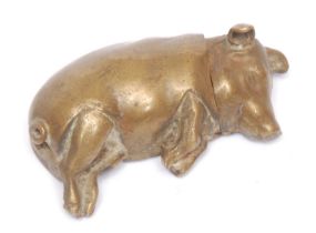 A 19th century brass novelty vesta case, as a pig, modelled sleeping, hinged cover, striker to base,