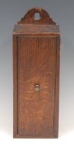 A George III oak candle box, arched cresting, sliding cover, 31cm high, c.1800