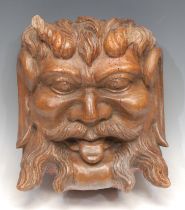 A large 19th century oak architectural boss, carved as a 'Green Man' foliate mask, 29cm long